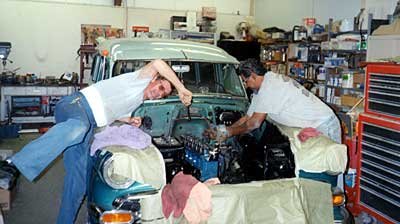Curtis Welch (right) lends a hand as Rudy Escalera works on the engine